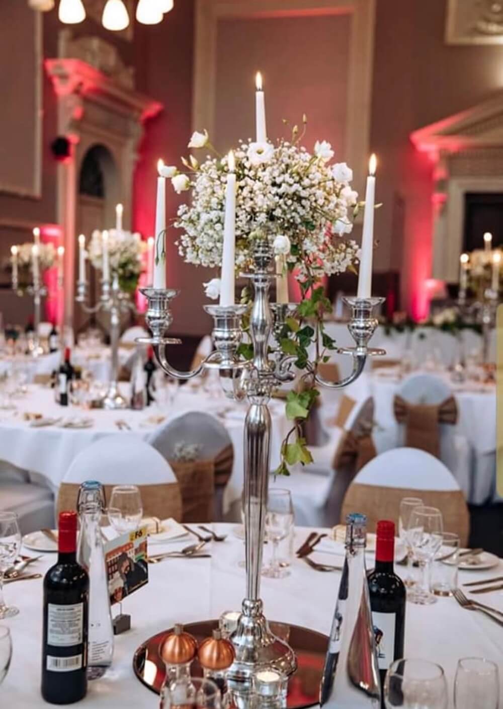 silver candelabra centrepiece for wedding reception table with white spray flowers and candles